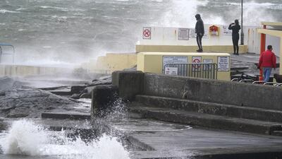 People look at the the waves at Blackrock Diving Board. PA