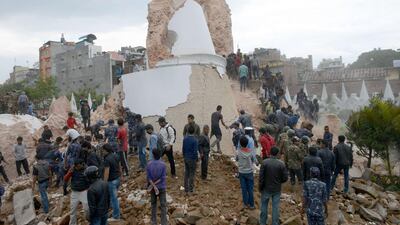 Nepalese rescue members and onlookers gather at the collapsed Darahara Tower in Kathmandu. Prakash Mathema / AFP