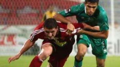 Al Ahli's Gad Folni and Al Shabab's Waled Abas Murad battle during the Super Cup.