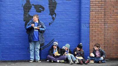 Children eat fish and chips before a football match at a park in Liverpool, England, October 19, 2013. Getty