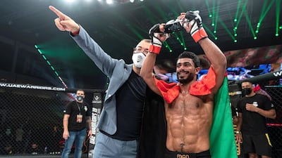 Omar Al Hussaini celebrates his debut win with Fouad Darwish, managing director of Palms Sports, in the UAE Warriors 19 Arabia 3 at the Jiu-Jitsu Arena. Courtesy UAE Warriors
