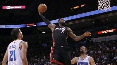 LeBron James, centre, says he will not be satisified until he has gone above and beyond what anyone else has accomplished in NBA history.