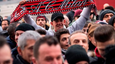 AC Milan supporters wait at the presentation. AFP