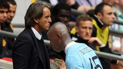 Manchester City Manager Roberto Mancini (R) shouts instructions as Chelsea Manager Carlo Ancelotti looks on during the Barclays Premier League match between Manchester City and Chelsea.