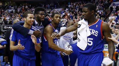 From left to right, Philadelphia 76ers' Michael Carter-Williams, Nerlens Noel, Hollis Thompson and Henry Sims celebrate in the final seconds of an NBA basketball game against the Detroit Pistons on Saturday, March 29, 2014, in Philadelphia. Philadelphia won 123-98, breaking a 26-game losing streak. AP Photo/Matt Slocum