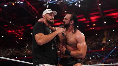 Tyson Fury joins a defeated Drew McIntyre in the ring.