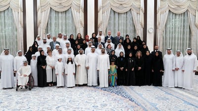 Sheikh Mohammed bin Rashid (front row 10th right), Sheikh Mohamed bin Zayed (front row 11th right), Sheikh Tahnoon bin Mohamed, Ruler's Representative in Al Ain Region (front row 12th right) and Sheikh Hamdan bin Mohammed, Crown Prince of Dubai (front row 13th right) stand for a photograph with members of Adheedak Group, during an iftar reception at Al Bateen Palace. Seen with Jameela Salem Al Muhairi, UAE Minister of State for Public Education Affairs (front row 9th right). Eissa Al Hammadi for the Ministry of Presidential Affairs