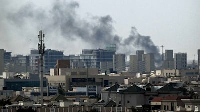 A plume of smoke rises over buildings in Doha on March 5, 2026. Multiple rounds of explosions echoed over Doha on March 5 just hours after officials said they were evacuating residents living near the US Embassy. AFP