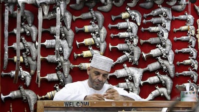 An Omani sits in front of a display of jambiyas (traditional daggers) in Muttrah Souq, the oldest market in Oman, in the capital, Muscat Reuters