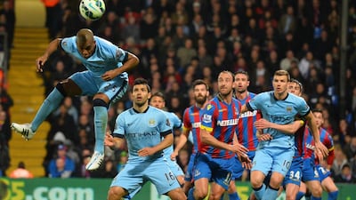 Manchester City's Fernandinho jumps to win a header during his side's Premier League match against Crystal Palace on Monday. Glyn Kirk / AFP