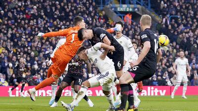 Leeds goalkeeper Illan Meslier punches the ball clear. PA