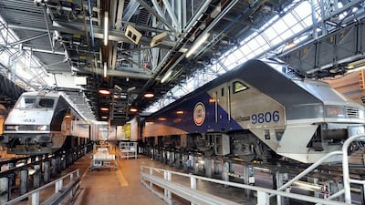 Eurotunnel trains in a hangar for maintenance in Coquelles, northern France. Up to 400 trains pass through the tunnel each day, carrying an average of 50,000 passengers, 6,000 cars, 180 coaches and 54,000 tonnes of freight. Denis Charlet / AFP