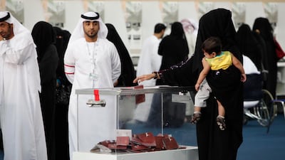 RAK, UAE. September 24, 2011. A voter casts her ballot at the Exhibition Centre in Ras Al Khaimah city on FNC election day. Antonie Robertson/The National