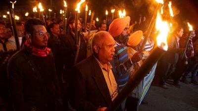 Indian protestors march in a torch light procession against the Citizenship Amendment act in Gauhati, India. AP