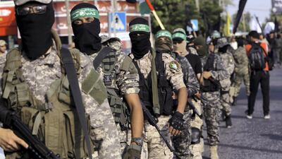 Masked militants from the Qassam Brigades, a military wing of Hamas, march with their rifles during a parade along the streets of Gaza City, Tuesday, July 25, 2017. AP