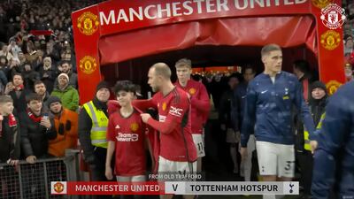 Christian Eriksen gives Dubai teenager Cameron Dean his jacket before their match against Tottenham on Sunday at Old Trafford. Photo: YouTube / Manchester United