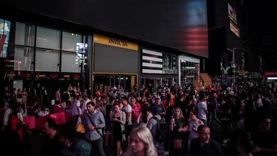 People walk along a dark street near the Times Square area. Reuters