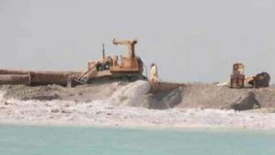 A dredger excavates sand along the Abu Dhabi coastline, but companies fear such contracts could slow.