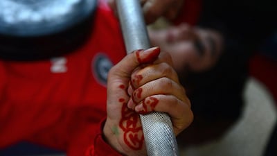 An Afghanistan national powerlifting team member takes part in a training session.