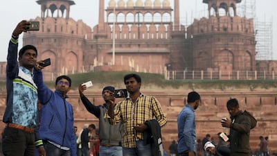 Domestic tourists take selfies in front of the historic Red Fort, one of the tourist destinations in the old quarters of Delhi, India. Saumya Khandelwal / Reuters