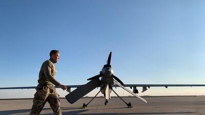 A US soldier walks past a drone in the Ain Al Asad airbase in the western Iraqi province of Anbar. AFP