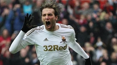 Swansea City attacker Michu celebrates.