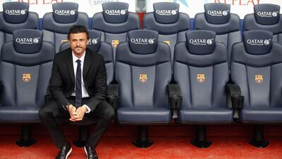 Barcelona's new coach Luis Enrique poses on a bench after signing a two-year contract at Camp Nou on May 21, 2014. Albert Gea / Reuters