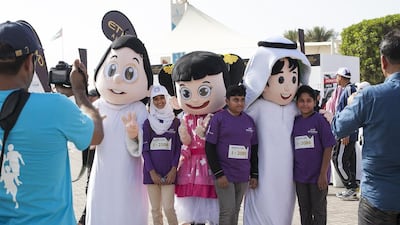 Majid magazine mascots pose for pictures with children at the charity run at the Corniche in Abu Dhabi. Mona Al Marzooqi / The National
