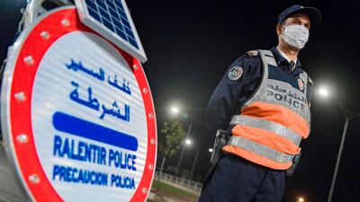 A Moroccan police officer mans a checkpoint during night curfew as a precaution against the novel coronavirus in the country's capital Rabat. AFP