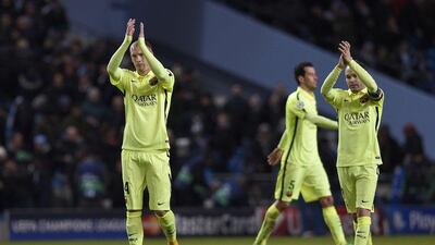 Barcelona's Ivan Rakitic, left, and Andres Iniesta, right, applaud the visiting fans after their 2-1 win over Manchester City at the Etihad Stadium on Tuesday in the Champions League last 16 first leg match. Lluis Gene / AFP
