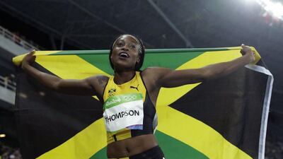 Jamaica’s Elaine Thompson celebrates with her country’s flag after winning gold in the women’s 100m final during the athletics competitions of the 2016 Summer Olympics at the Olympic stadium in Rio de Janeiro, Brazil, Saturday, August 13, 2016. Matt Dunham / AP Photo