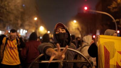 A protestor gestures outside the Camp Nou stadium in Barcelona. AP