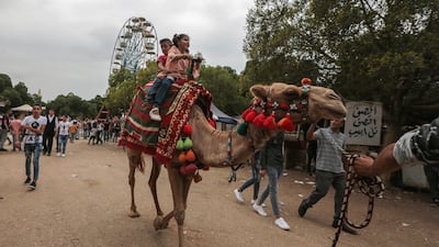 epa06962790 Children ride a camel at the popular amusement park 'Horsh Beirut' to celebrate Eid Al-Adha in Beirut, Lebanon, 21 August 2018. Eid al-Adha is the holiest of the two Muslims holidays celebrated each year, it marks the yearly Muslim pilgrimage (Hajj) to visit Mecca, the holiest place in Islam. Muslims slaughter a sacrificial animal and split the meat into three parts, one for the family, one for friends and relatives, and one for the poor and needy. EPA-EFE/NABIL MOUNZER
