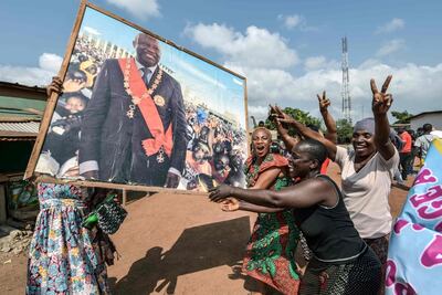 People celebrate with a portrait of former Ivory Coast president Laurent Gbagbo on January 15, 2019 in his birth-town Gagnoa. AFP