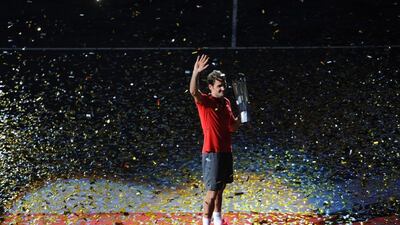 Roger Federer waves to the crowd with his trophy after winning the Shanghai Masters tournament on Sunday in China. Goh Chai Hin / AFP / October 12, 2014