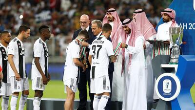 Juventus players receive their medals post match. Reuters