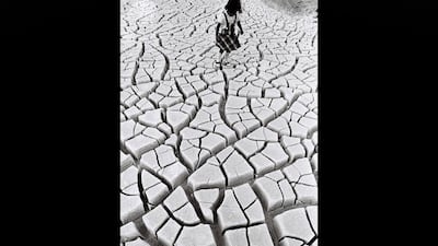On land near where the Emirates Palace now stands in Abu Dhabi, a young girl plays hopscotch on the fractured, arid ground. Courtesy Al Ittihad