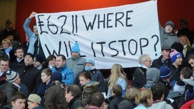 Fans hold a banner in the stands relating to the price of tickets during the Barclays Premier League match at The Emirates Stadium, London.