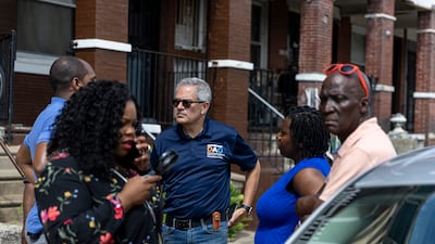 District Attorney Larry Krasner and other officials walk through the neighbourhood the morning after the mass shooting. AP