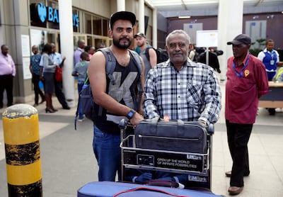 Ahmed Khalid with his father after arriving at Jomo Kenyatta International Airport in Nairobi. Reuters