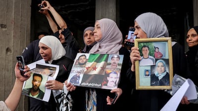 People gather in a street in Tadamon, Syria to celebrate the arrest of Amjad Yousef, a key suspect in the 2013 massacre in the city. Reuters