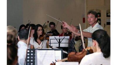 Philipp Maier, shown conducting a rehearsal of the UAE Philharmonic Orchestra, writes in a letter to the editor that the UAE does not have enough musicians for two symphony orchestras. Randi Sokoloff for The National