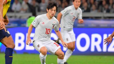 Japan's Shoya Nakajima dribbles with the ball against Ecuador. AFP