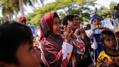 Children sing during a trauma healing class at a temporary shelter outside the grand mosque in Palu. EPA
