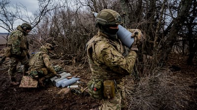 A Ukrainian serviceman near Bakhmut carries a 152mm shell to fire a Msta-B howitzer towards Russian positions. AFP