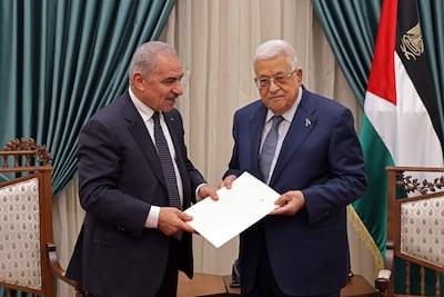Former prime minister Mohammad Shtayyeh presents the resignation of his government to President Mahmoud Abbas in Ramallah on Monday. AFP