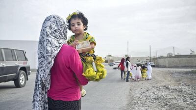 Emirati children, dressed in their new Eid clothes, walk through their neigbourhood in Ras Al Khaimah on the morning of Eid at the end of the Holy Month of Ramadan recieving money in cash called "Eideeyah" as a gift. August 8, 2013. Antonie Robertson / The National