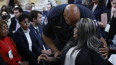 US Capitol Police Officer Harry Dunn hugs Wandrea “Shaye” Moss, a former Georgia election worker, after she testified during the fourth hearing on the January 6 investigation. Getty / AFP