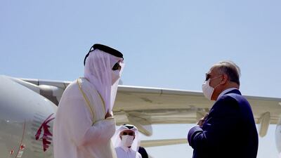 Iraqi Prime Minister Mustafa Al Kadhimi greets Qatar’s Emir Sheikh Tamim on his arrival in Baghdad. AFP