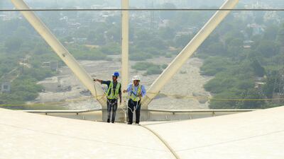 A safety officer oversees construction work at the Motera stadium. AFP